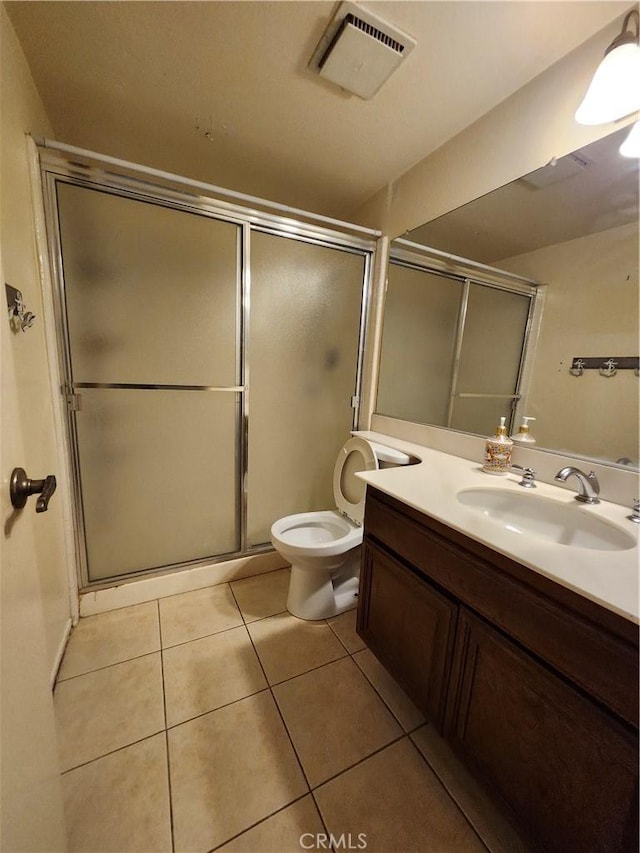bathroom featuring a shower stall, tile patterned floors, visible vents, and toilet