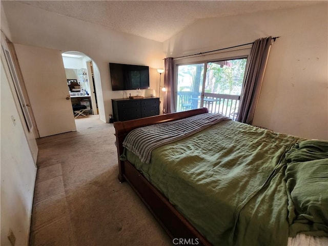 carpeted bedroom with access to exterior, arched walkways, and lofted ceiling