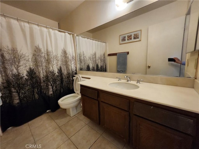 bathroom featuring toilet, vanity, and tile patterned flooring