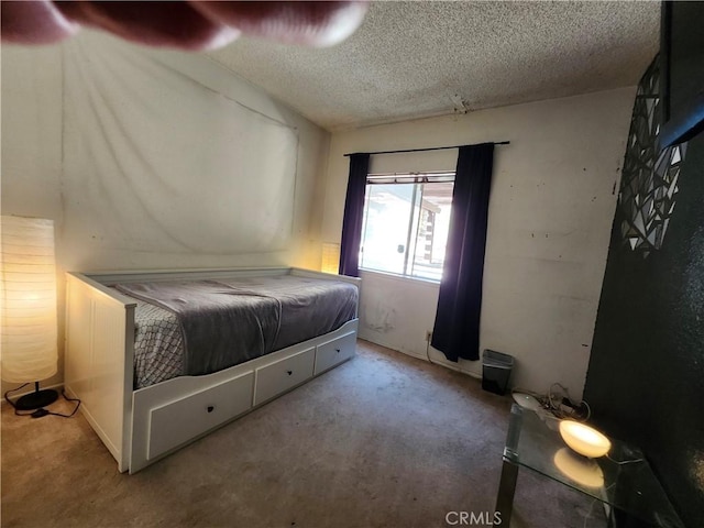 bedroom with carpet and a textured ceiling