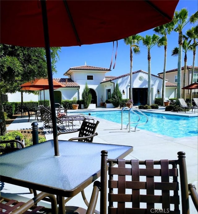 community pool with a patio area