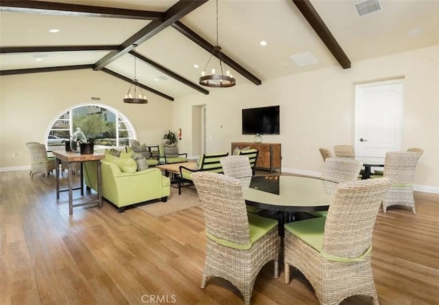 dining area with visible vents, baseboards, vaulted ceiling with beams, and light wood-style floors