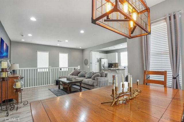 dining area with recessed lighting, plenty of natural light, and light wood-style flooring