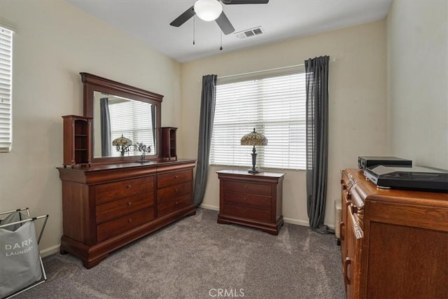 interior space with baseboards, a ceiling fan, carpet flooring, and visible vents