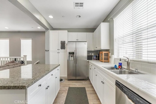 kitchen with a sink, light wood-style floors, appliances with stainless steel finishes, visible vents, and recessed lighting