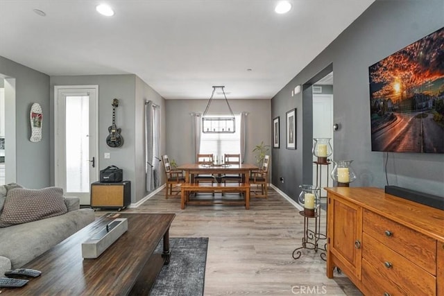 living room with recessed lighting, light wood finished floors, and baseboards