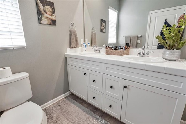 full bath with a wealth of natural light, a sink, and toilet