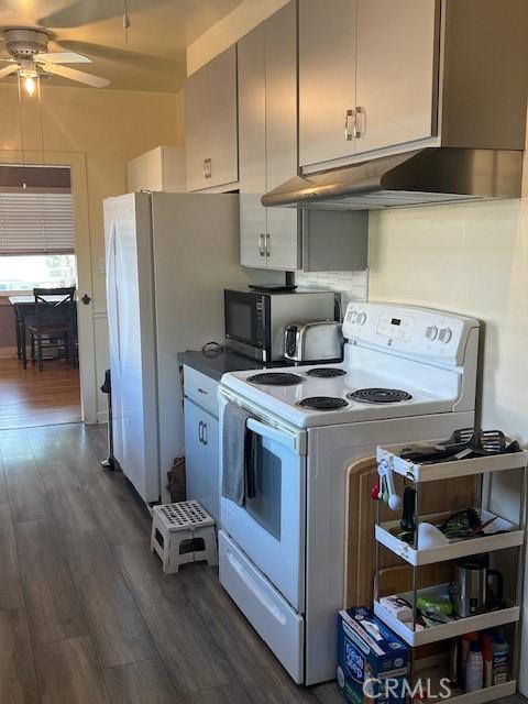 kitchen featuring white cabinets, white appliances, dark wood-style floors, and ceiling fan