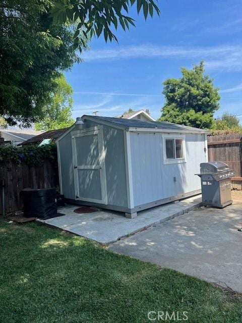 view of shed featuring fence