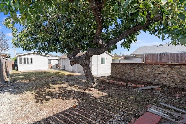 view of yard featuring a fenced backyard and an outdoor structure