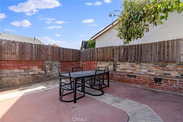 view of patio / terrace featuring outdoor dining space and fence