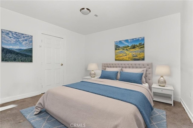 bedroom with baseboards and carpet