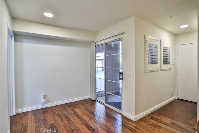 doorway featuring baseboards, recessed lighting, and wood finished floors