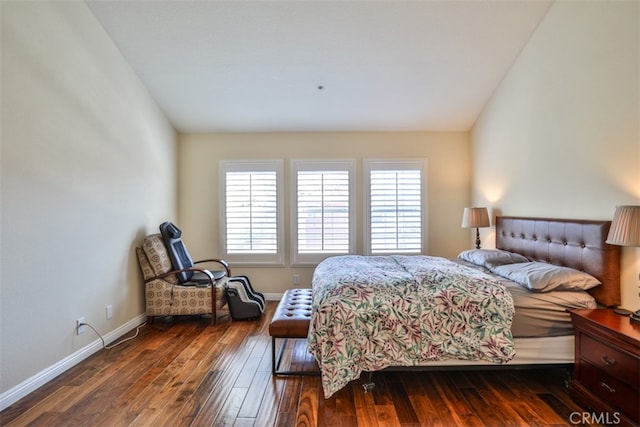 bedroom featuring baseboards and dark wood-style flooring