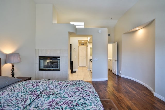 5 Arese Aisle, Irvine, CA 92606 - bedroom featuring wood finished floors, a tile fireplace, and baseboards