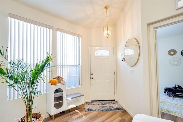 28751 Broadstone Way, Menifee, CA 92584 - entrance foyer with light wood-style flooring, a chandelier, and baseboards