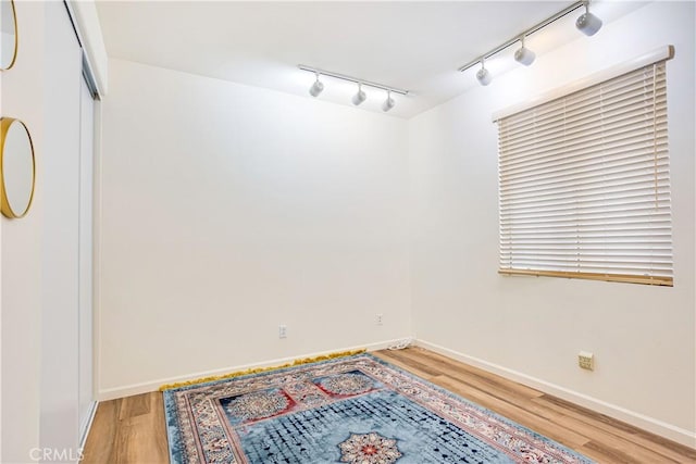 28751 Broadstone Way, Menifee, CA 92584 - unfurnished room with rail lighting, light wood-style flooring, and baseboards