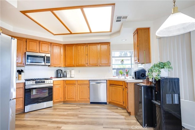 28751 Broadstone Way, Menifee, CA 92584 - kitchen with appliances with stainless steel finishes, light countertops, light wood-type flooring, and pendant lighting