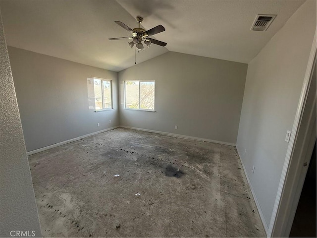 empty room featuring baseboards, visible vents, a ceiling fan, and vaulted ceiling