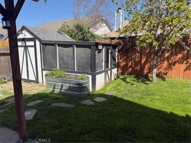 view of yard with fence and an outbuilding