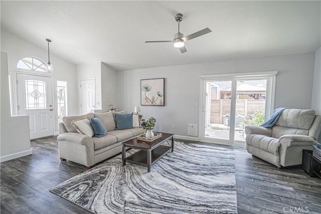 living area featuring wood finished floors, baseboards, a ceiling fan, and vaulted ceiling