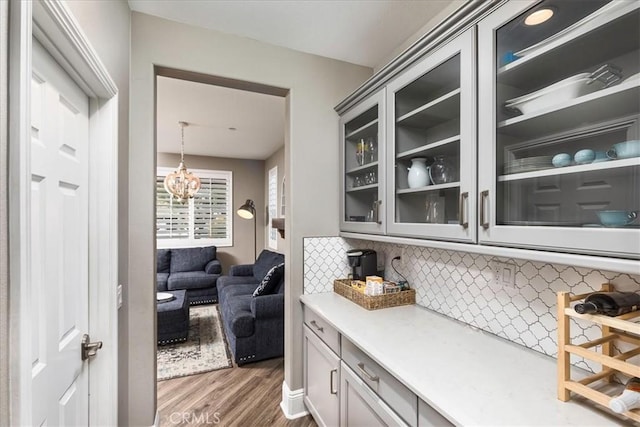 30580 Hawkscrest Rd, Murrieta, CA 92563 - bar with an inviting chandelier, backsplash, and wood finished floors