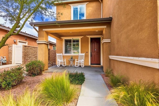 30580 Hawkscrest Rd, Murrieta, CA 92563 - doorway to property featuring stucco siding, fence, and covered porch