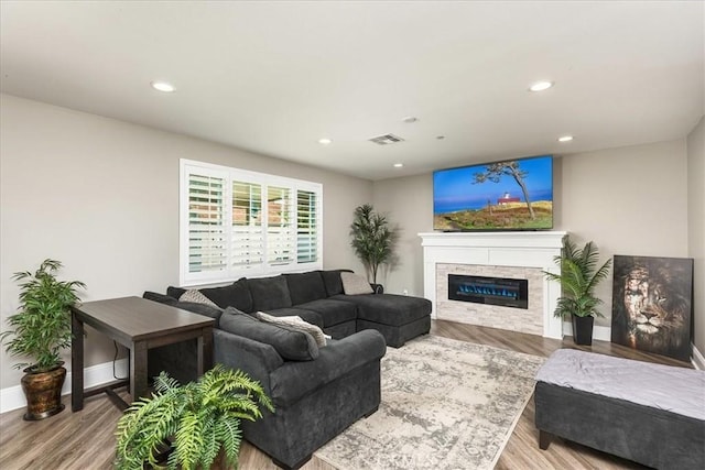 30580 Hawkscrest Rd, Murrieta, CA 92563 - living area with a glass covered fireplace, baseboards, recessed lighting, visible vents, and wood finished floors
