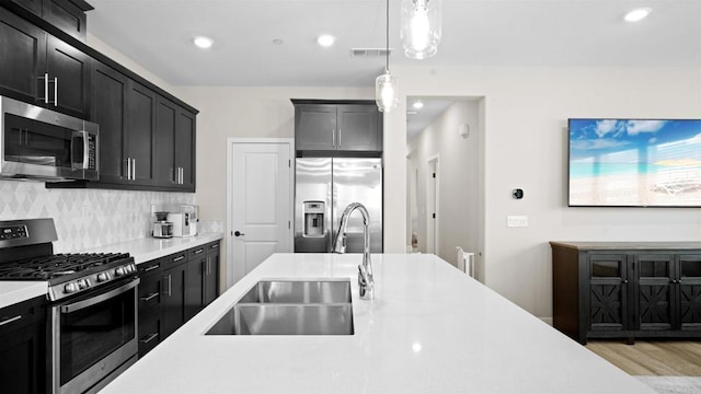 10861 Blake Way, San Diego, CA 92129 - kitchen with appliances with stainless steel finishes, light countertops, tasteful backsplash, pendant lighting, and recessed lighting