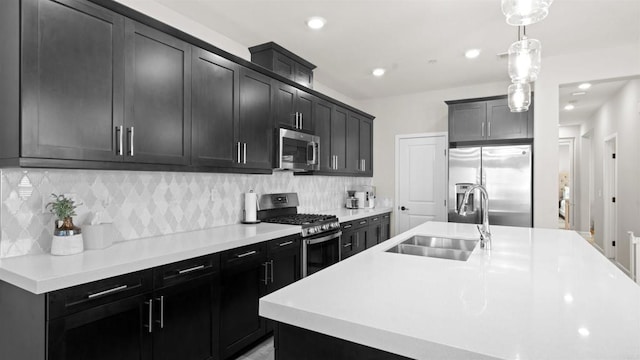 10861 Blake Way, San Diego, CA 92129 - kitchen featuring appliances with stainless steel finishes, dark cabinets, hanging light fixtures, light countertops, and recessed lighting