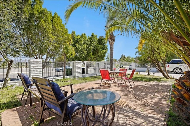 view of patio / terrace featuring fence and outdoor dining space