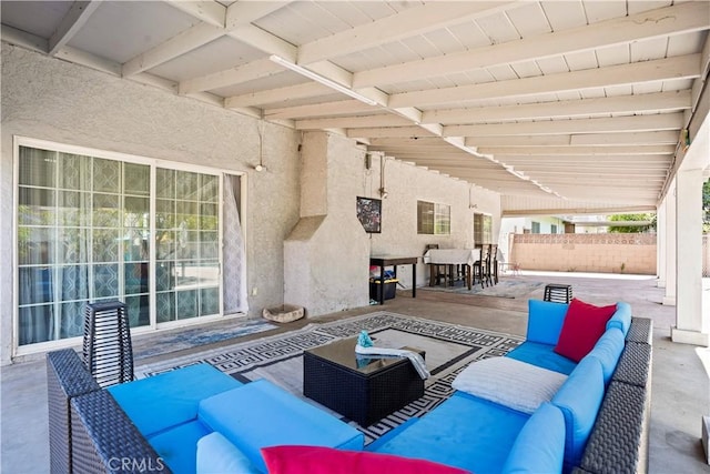 view of patio with outdoor lounge area and fence