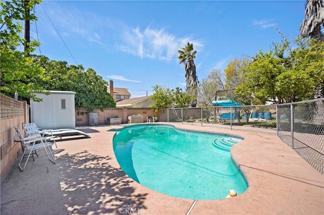view of pool featuring a patio area, a fenced in pool, and fence