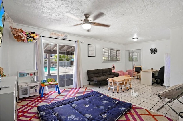 tiled living room with a textured ceiling, ceiling fan, and crown molding