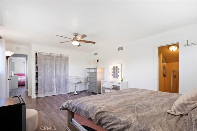 bedroom featuring ceiling fan, wood finished floors, and visible vents