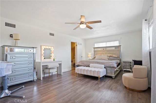 bedroom featuring wood finished floors, visible vents, and ceiling fan