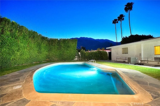 1261 Linda Vista Rd, Palm Springs, CA 92262 - view of swimming pool featuring a mountain view, central air condition unit, and a patio