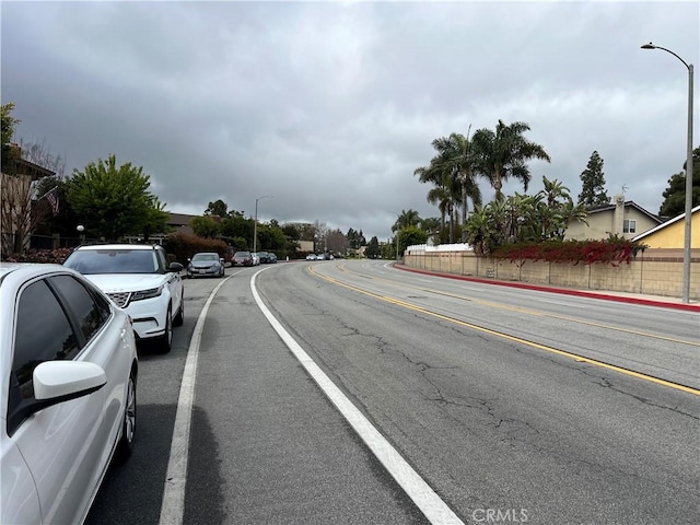 1111 S Coast Dr Unit 18, Costa Mesa, CA 92626 - view of asphalt street featuring street lights, curbs, and sidewalks