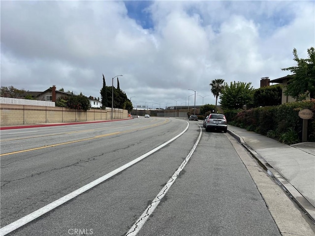 1111 S Coast Dr Unit 18, Costa Mesa, CA 92626 - view of asphalt street featuring sidewalks, street lighting, and curbs