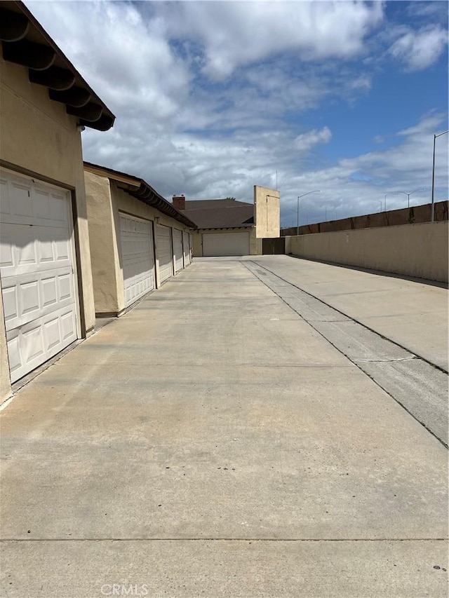 1111 S Coast Dr Unit 18, Costa Mesa, CA 92626 - view of concrete road with community garages