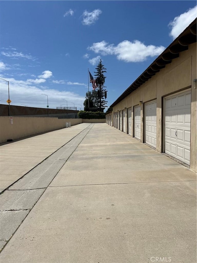 1111 S Coast Dr Unit 18, Costa Mesa, CA 92626 - view of concrete road featuring community garages and street lighting