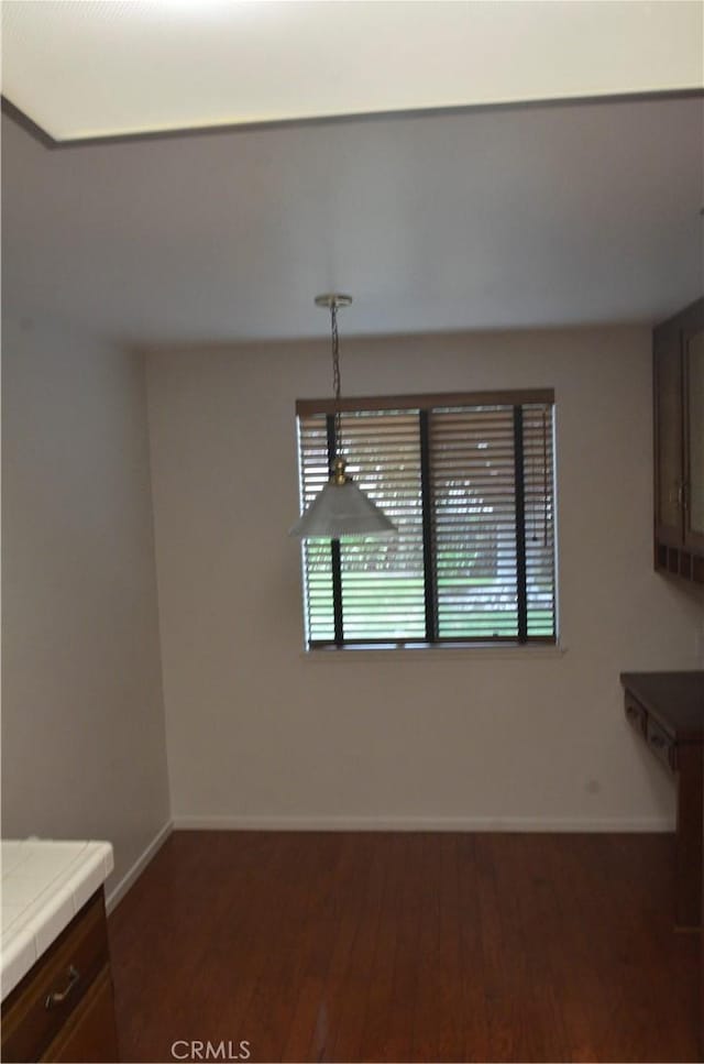 1111 S Coast Dr Unit 18, Costa Mesa, CA 92626 - unfurnished dining area with wood finished floors and baseboards