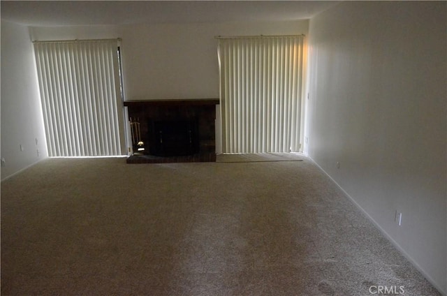 1111 S Coast Dr Unit 18, Costa Mesa, CA 92626 - unfurnished living room with carpet and a fireplace