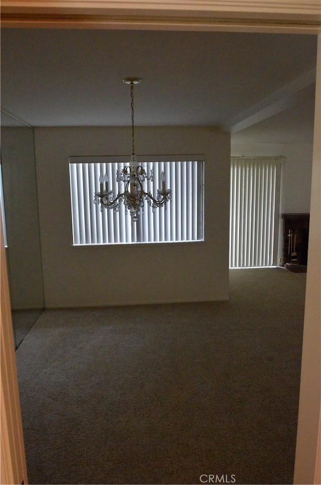1111 S Coast Dr Unit 18, Costa Mesa, CA 92626 - carpeted empty room with plenty of natural light and a chandelier