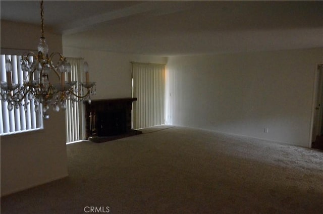 1111 S Coast Dr Unit 18, Costa Mesa, CA 92626 - unfurnished living room with carpet floors, a chandelier, and a fireplace with raised hearth