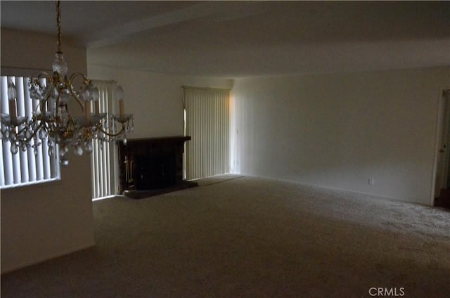 1111 S Coast Dr Unit 18, Costa Mesa, CA 92626 - unfurnished living room with carpet flooring, a chandelier, and a fireplace with raised hearth