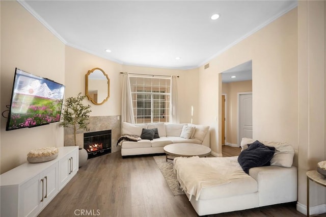 2256 Montrose Ave Unit 14, Montrose, CA 91020 - living room featuring wood finished floors, a tiled fireplace, ornamental molding, and visible vents