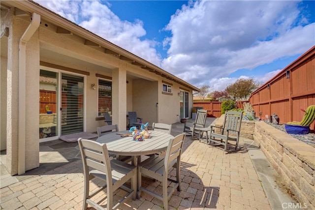 view of patio with a fenced backyard and outdoor dining space