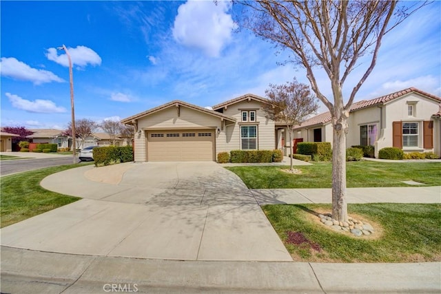 mediterranean / spanish house with an attached garage, driveway, a front lawn, and a tile roof