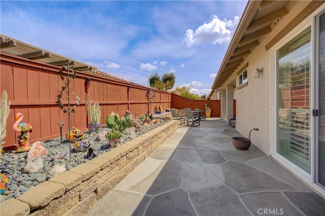 view of patio featuring outdoor dining space and a fenced backyard